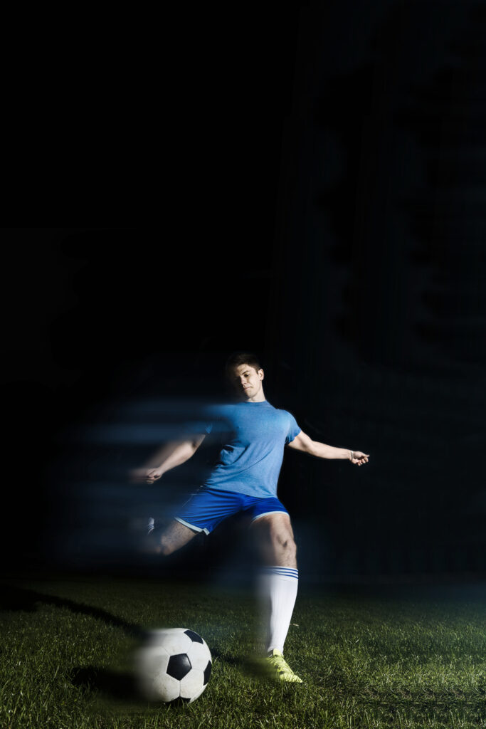 young-sportsman-kicking-soccer-ball